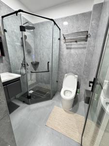 a bathroom with a shower and a toilet at Lovely one bedroom in Kilimani near yaya centre in Nairobi +11 photos
