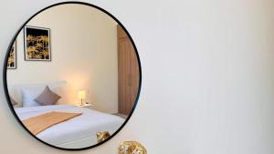 a bedroom with a mirror on a white wall at Luxurious apartments at JLT by Checkmyguest in Dubai