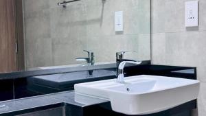 a bathroom with a white sink and a mirror at Luxurious apartments at JLT by Checkmyguest in Dubai