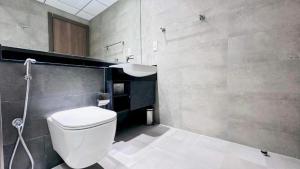 a bathroom with a white toilet and a sink at Luxurious apartments at JLT by Checkmyguest in Dubai