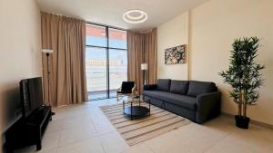 a living room with a couch and a large window at Luxurious apartments at JLT by Checkmyguest in Dubai