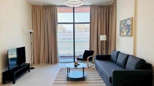 a living room with a couch and a tv at Luxurious apartments at JLT by Checkmyguest in Dubai