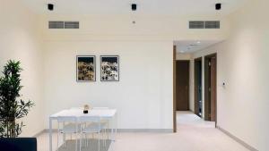 a white dining room with a white table and chairs at Luxurious apartments at JLT by Checkmyguest in Dubai