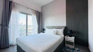 a bedroom with a large bed and a large window at Luxurious apartments at JLT by Checkmyguest in Dubai