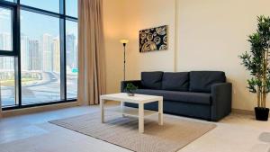 a living room with a couch and a table at Luxurious apartments at JLT by Checkmyguest in Dubai