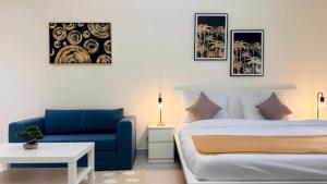 a bedroom with a bed and a blue couch at Luxurious apartments at JLT by Checkmyguest in Dubai