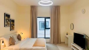 a bedroom with a large bed and a television at Luxurious apartments at JLT by Checkmyguest in Dubai