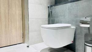 a bathroom with a white toilet and a shower at Luxurious apartments at JLT by Checkmyguest in Dubai