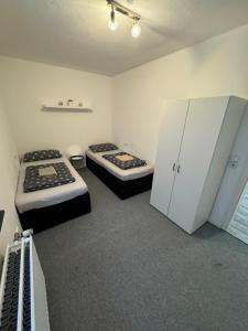 a room with two beds and cabinets in it at Gemütliche 3 Zimmer Wohnung Linden in Wolfenbüttel +25 photos
