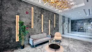 a living room with a couch and a chandelier at Luxurious apartments at JLT by Checkmyguest in Dubai +37 photos