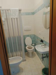 a bathroom with a toilet and a sink at Locanda Zona Franca in San Benedetto del Tronto