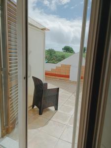 a balcony with a chair and a view of a patio at Locanda Zona Franca in San Benedetto del Tronto