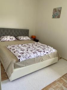 a large bed in a bedroom with a bed frame at Apartman Fad in Bihać