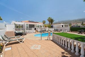 a man standing on a patio in front of a house at Villa Milena in Callao Salvaje