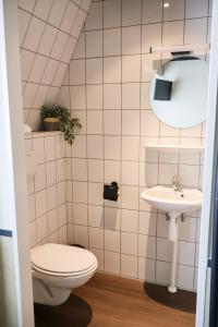 a bathroom with a toilet and a sink at Hotel de Abdij in Horn +23 photos