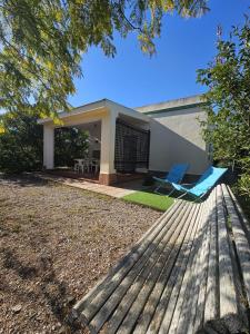 a house with two chairs and a porch at El Arrabal de la Barrosa in Chiclana de la Frontera