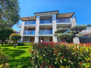a building with a garden in front of it at Pension Silvia in Portorož