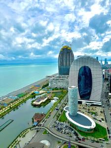 an aerial view of a city with a building at Seaside vip Hotel in Batumi