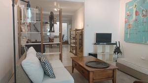 a living room with a couch and a table at Chez Marie, maison ArtY in Lauzun