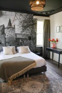 a bedroom with a large bed with a wall at Hotel de Abdij in Horn