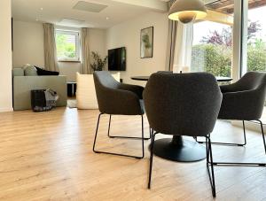 a living room with a table and chairs at 2 Wohnungen im Haus mit Sauna & Bergblick, 2 Küchen, 2 Bäder in Siegsdorf