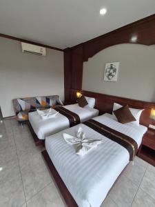a hotel room with two beds and avisor at New Forest Patong in Patong Beach