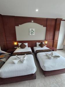a hotel room with two beds with bows on them at New Forest Patong in Patong Beach