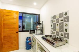 a kitchen with a stove and a window at Happy Time Pool Villa in Ban Nong Chaeng
