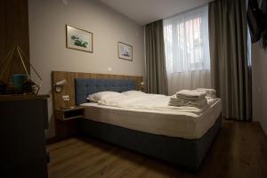 A bed or beds in a room at AquaSun Family Hotel