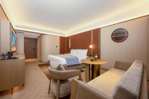 a hotel room with a bed and a table at 西安明城墙永兴坊桔子水晶酒店 in Xi'an
