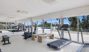 ein Fitnessstudio mit mehreren Laufbändern und Cardiogeräten in der Unterkunft Elegant Apartment in Vitta Natura Mijas in Mijas Costa