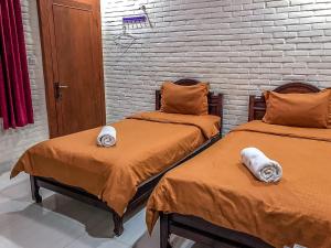 Katil atau katil-katil dalam bilik di Arys Garden Hotel Yogyakarta