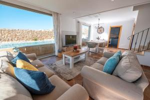 un salon avec deux canapés et une télévision dans l'établissement Cala Agulla 1, à Cala Ratjada