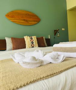 two towels are sitting on top of a bed at TT House Gili Air in Gili Islands
