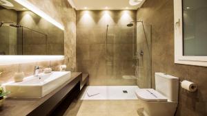 a bathroom with a sink and a toilet and a shower at Fisa Rentals Ramblas Apartments in Barcelona +100 photos