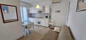 a living room with a couch and a kitchen at Appartamenti Lino in Caorle