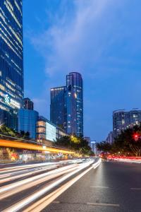 a city street at night with tall buildings at Mercure Guangzhou Tianhe Sports Center in Guangzhou