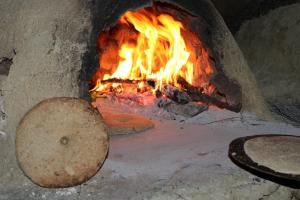 a brick oven with a fire in it at Gite Skoura in Caïd Bou Malla