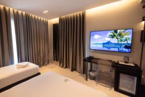 a hotel room with a flat screen tv on the wall at Hotel Majestic in Vlorë