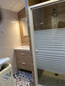 a bathroom with a shower with a glass door at Maison Algus in Cucq +2 photos