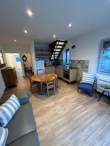 a living room with a couch and a table at Maison Algus in Cucq