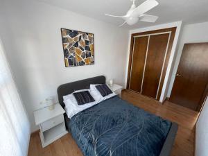 a bedroom with a bed and a ceiling fan at Casa del Sol - Santiago de la Ribera, San Javier, 600 m from the beach, swimming pool in San Javier +56 photos