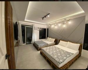 a bedroom with two beds in a room at Amazing 4 bedroom Home in Batangas City