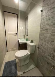 a bathroom with a toilet and a sink and a shower at Amazing 4 bedroom Home in Batangas City