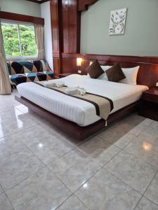 a bedroom with a large bed in a room at New Forest Patong in Patong Beach