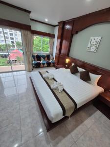a bedroom with a large bed and a couch at New Forest Patong in Patong Beach