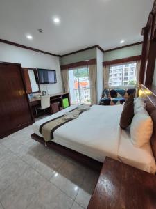 a large bedroom with a large bed and a window at New Forest Patong in Patong Beach