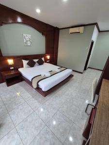 a bedroom with a large bed in a room at New Forest Patong in Patong Beach