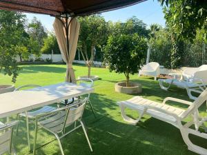 a group of white tables and chairs in a yard at Visitar-Bioucas-I-AL-Q-Nature-and-Well-being-RNAL-43962-AL 
