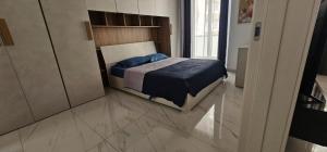 a bedroom with a bed with a blue blanket at Central Apartment Sliema John in Sliema +30 photos